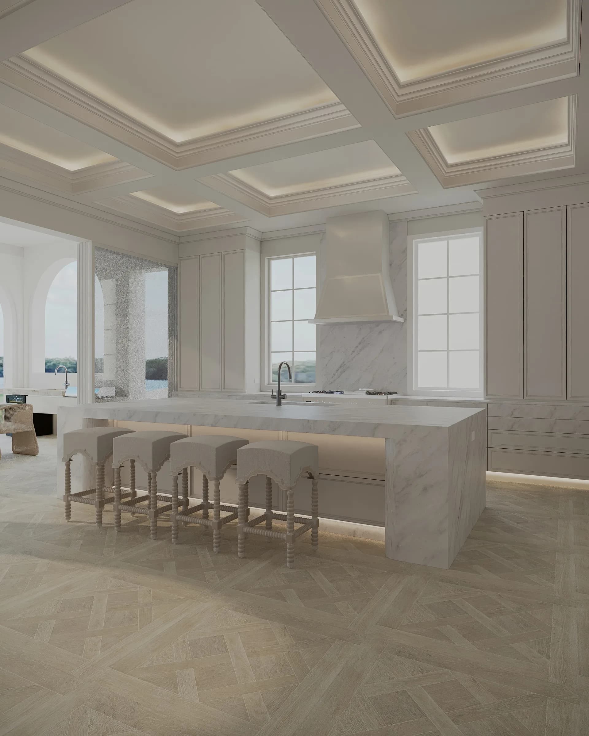 White marble waterfall kitchen island with counter stools under a coffered ceiling at a Sovereign Islands residence.